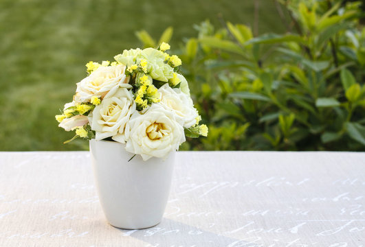 Floral arrangement with yellow roses