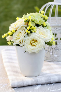 Floral arrangement with yellow roses