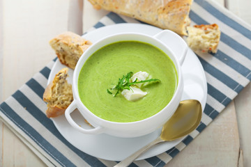 Cream soup made of broccoli on table. Traditional European food. Top view.