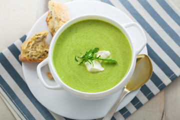 Delicious spinach cream soup with rye bread on a table. International meal. Top view.