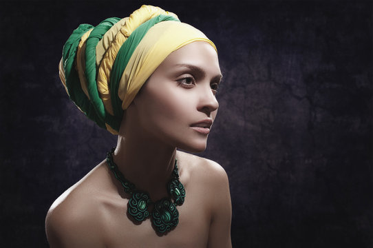 girl in color turban with a green jewelery on his neck