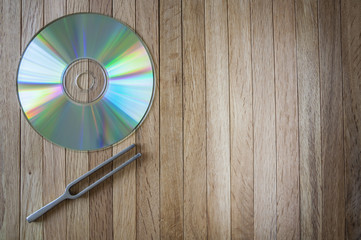 Compact Disc and Tuning Fork on Desk top view