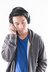 Young man listening to music with headphone