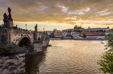 Fototapeta na wymiar Shining Prague castle and Charles bridge in the early evening, Czech Republic, Europe