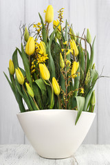 Spring floral arrangement with yellow tulips
