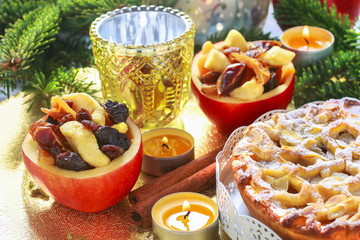 Naklejka na ściany i meble Apple pie on and stuffed apples on christmas table