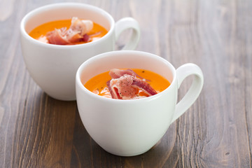 cold summer spanish soup in white cup on brown wooden background