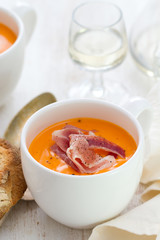 cold soup with smoked meat in white cup with wine and spoon