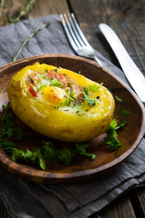 Potatoes stuffed with bacon, greens and eggs