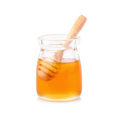 Glass jar full of honey wooden honey dipper