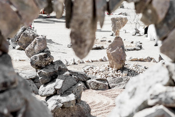 Unusual piles of stones of different sizes. Unequal stones glued together in the park. 