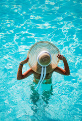 Woman on vacation relaxing by the pool