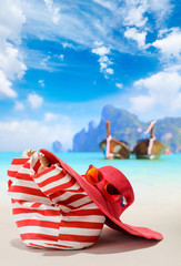 Summer beach bag with red  straw hat and sunglasses
