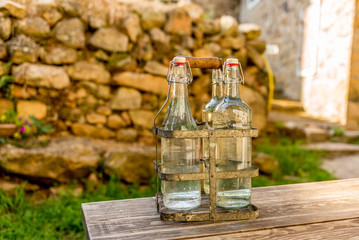 Bottles of cold spring water during summer in the mountains in C