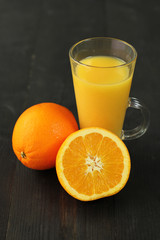 Fresh oranges and orange juice on the table