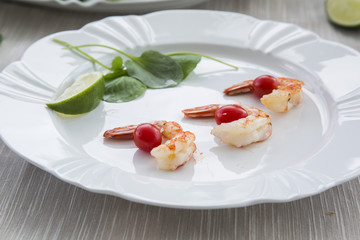Fried shrimp with lemon on a old wooden background
