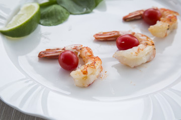 Fried shrimp with lemon on a old wooden background