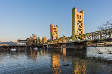 Gold Tower Bridge, in Sacramento California during blue sunset with downtown and goose