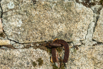 Old horse shoe hanging in a stone wall
