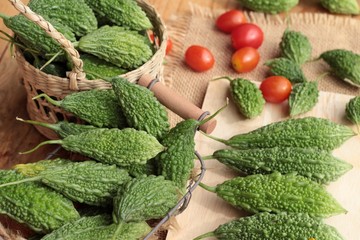 Bitter melon and sliced on wood background.