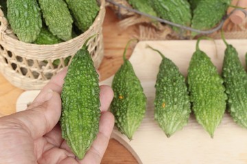 Bitter melon and sliced on wood background.