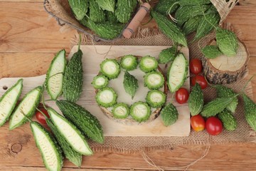 Bitter melon and sliced on wood background.