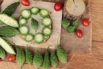 Bitter melon and sliced on wood background.
