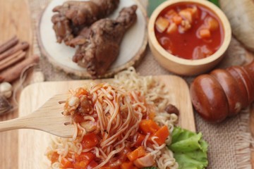 Chicken noodle with sauce tomato is delicious.