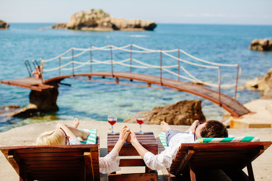 honeymoon couple relax on beach wth sea view