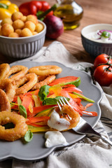 Batter fried squid rings with potato croquettes and pepper salad
