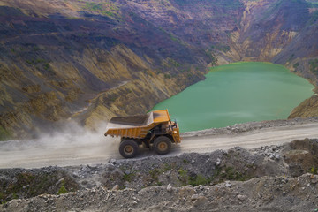 Yellow dump truck on coper surface mining