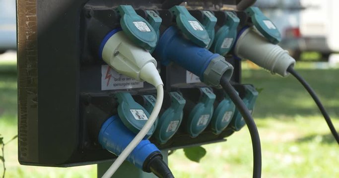 Camping electricity adapters plugged into sockets