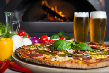 Pizza ordered in traditional italian restaurant with beer company