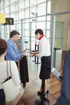 Businessman showing his boarding pass at the check-in counter