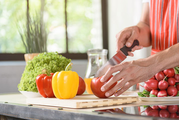 Young guy cooking healthy food at home