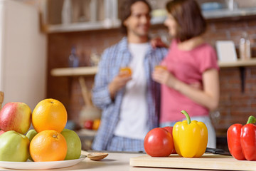 Married couple with healthy food in kitchen