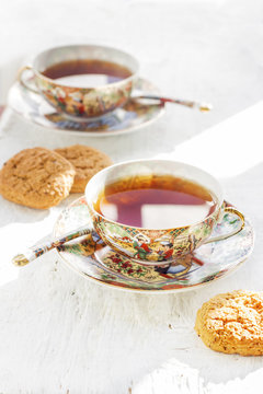 Two iapan's stily cups of tea with cookie