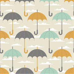 Fototapeta na wymiar Seamless texture. Autumn. Depicts the umbrellas of the same size .Umbrella in three colors : grey, yellow and blue .Umbrellas in the clouds. Umbrellas on a beige background.