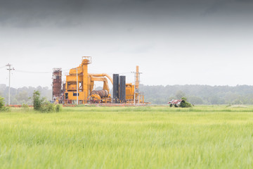 Obraz premium Industrial chimneys of a chemical factory in the middle of a gre
