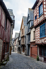Fototapeta na wymiar Narrow street with medieval half timbered houses from Brittany, France