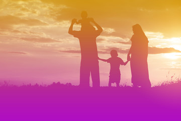 Fototapeta premium Happy family dancing on the road in the sunset time. Evening par