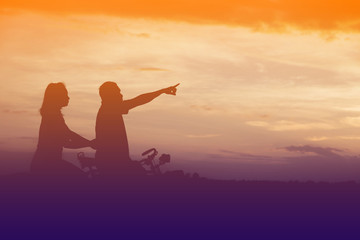 Silhouette of father use hand point his son look at meteor showe