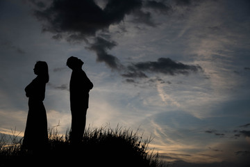 Silhouette of a angry woman and man on each other