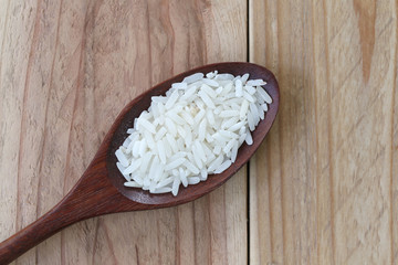 Organic jasmine rice in wooden spoon.