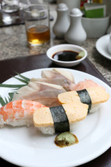 Seafoods Sushi on white dish in the restaurant.