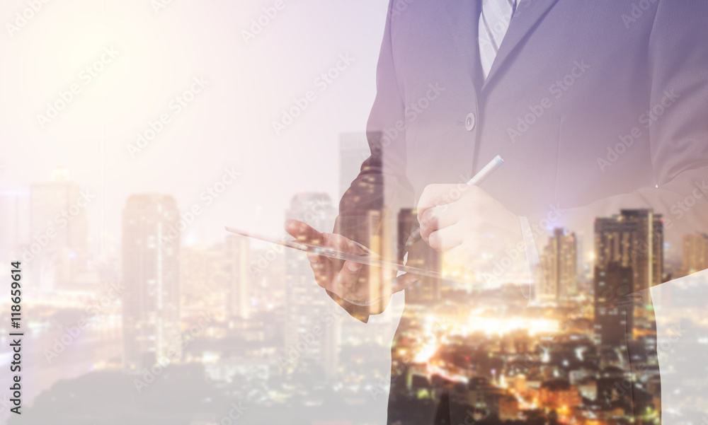 Poster double exposure of business man working with a digital tablet with cityscape blurred building backgr