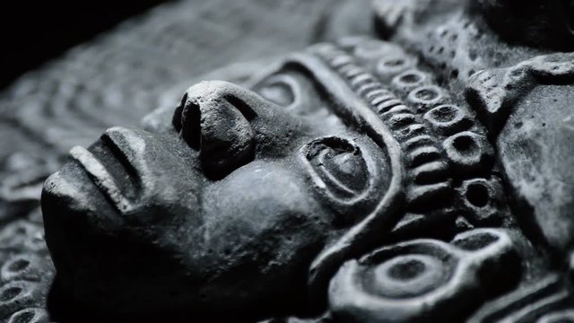 Sculpture in stone of face of ancient art south american aztec, inca, olmeca