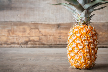  pineapple on wooden background with copyspace 