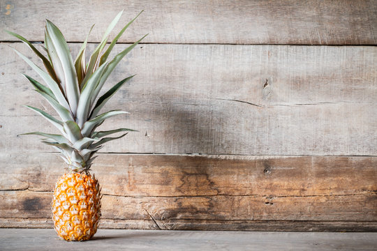  pineapple on wooden background with copyspace 