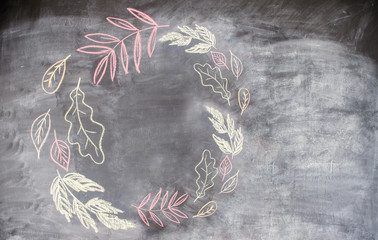 Chalk pattern of autumn leaves on slate with copy space